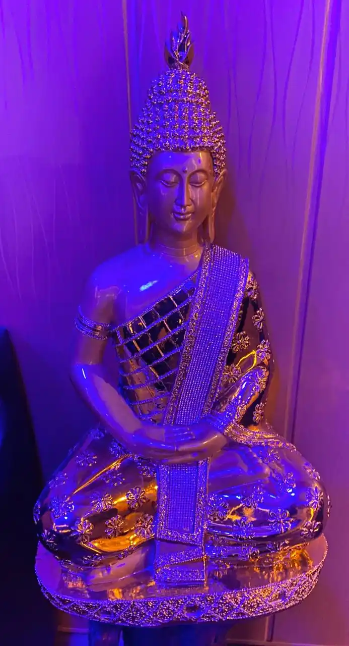 buddha idol under blue lighting in swan spa in lucknow